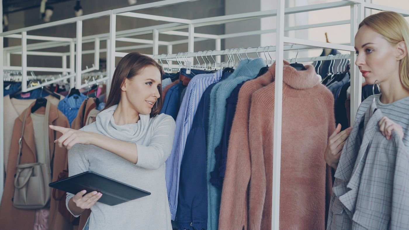 Retail associates exploring a clothing collection with a tablet